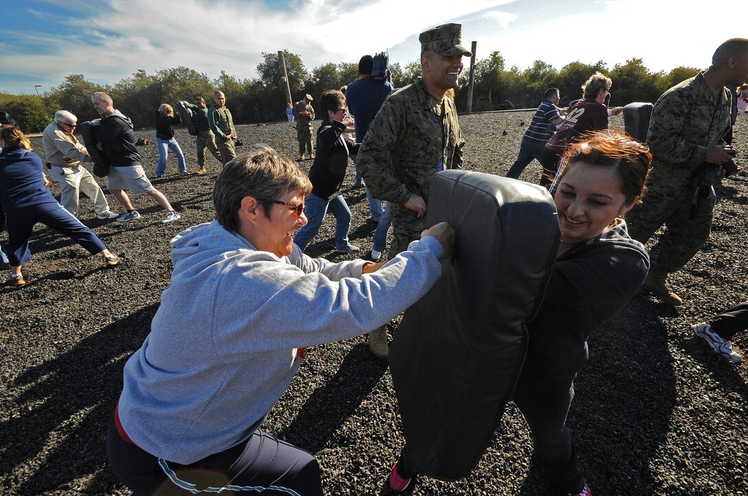 Jessica Gamboa, of Miami High School, Miami Ariz., holds a Marine Corps Martial Arts Program bag as Judy Fisher, a teacher with Sahuarita High School, Sahuarita, Ariz., performs a lead hand punch aboard Marine Corps Recruit Depot San Diego, Calif. on March 1. Each year educators throughout the 10 states, which make up the 8th Marine Corps District, participate in the Educators Workshop, a five day event in Southern Calif. which allows high school teachers to experience Marine Corps recruit training.